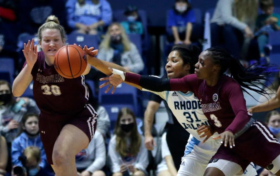 Fordham's Maranda Nyborg, left, and Asiah Dingle lunge for a ball knocked loose by URI defender Emmanuelle Tahane in a 2022 game in Kingston. Nyborg is joining the Bryant Bulldogs.