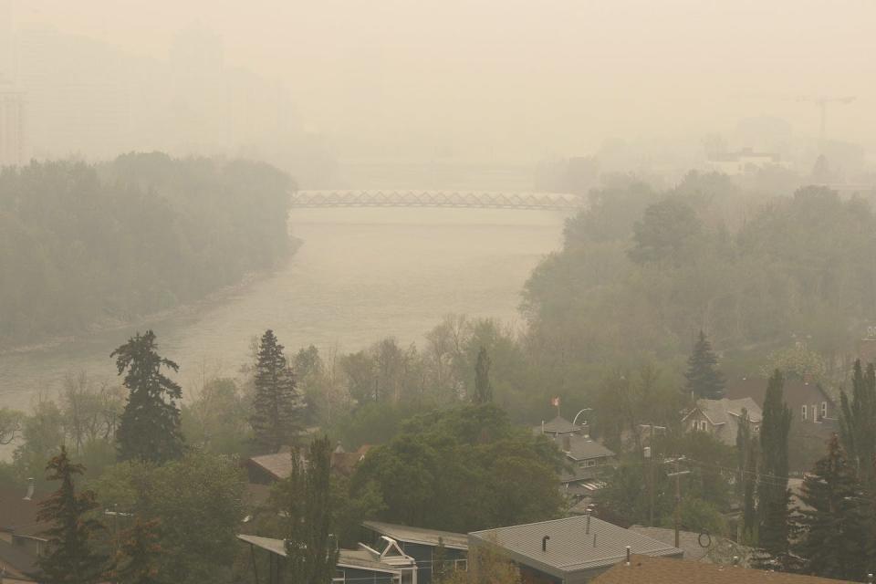 Heavy smoke from Alberta forest fires comes south to blanket the Bow River area in downtown Calgary, Alta., May 16, 2023. THE CANADIAN PRESS/Larry MacDougal