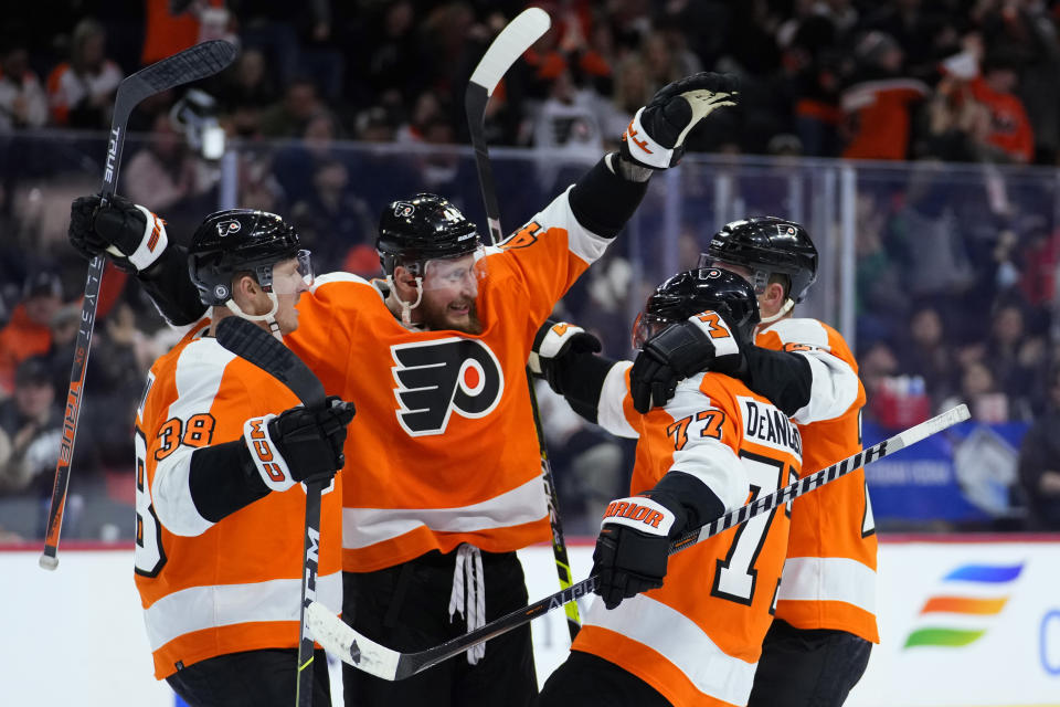 Philadelphia Flyers' Patrick Brown, from left, Nicolas Deslauriers, Tony DeAngelo, and Nick Seeler celebrate after a goal by Deslauriers during the second period of an NHL hockey game against the New York Islanders, Monday, Feb. 6, 2023, in Philadelphia. (AP Photo/Matt Slocum)