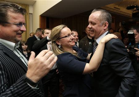 Slovakia's presidential candidate Andrej Kiska (R) is congratulated by his supporters at his party headquarters after the first unofficial results showed he won the presidential run-off elections in Bratislava March 29, 2014. REUTERS/David W Cerny