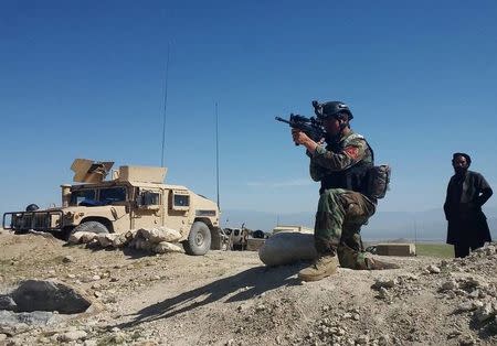 A member of Afghanistan's special forces point his gun as he observes the enemy lines in Achin district of Nangarhar province, in eastern Afghanistan April 14, 2017. REUTERS/Parwiz