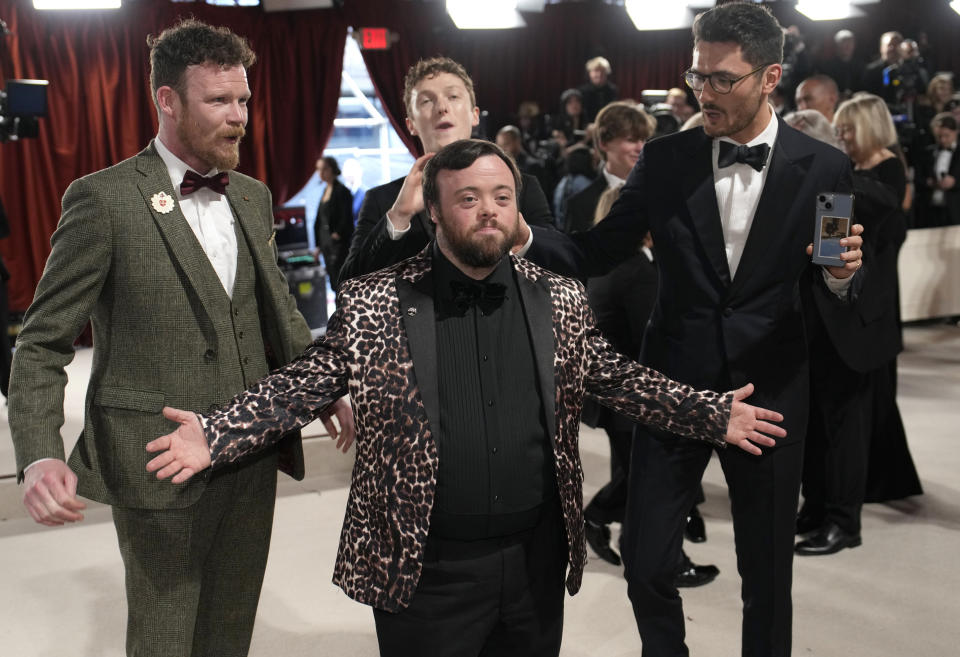 FILE - Seamus O'Hara, from left, James Martin, Ross White and Tom Berkeley arrive at the Oscars on Sunday, March 12, 2023, at the Dolby Theatre in Los Angeles. Singer Shirley Bassey, director Ridley Scott and England goalkeeper Mary Earps were recognized Friday, Dec. 29, 2023 in the U.K.’s New Year Honors list, which celebrates the achievements and services of more than 1,000 people across the country. Other well-known names on the list include “The Great British Bake Off” judge Paul Hollywood, “Game of Thrones” actor Emilia Clarke, and Justin Welby, the Archbishop of Canterbury. (AP Photo/John Locher, File)