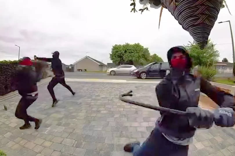 Balaclava-clad men at Nikia's address in Doncaster, who smashed the front door with a crowbar -Credit:Nikia Marshall© SWNS