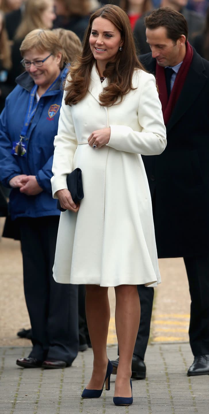 Kate in a Knee-Length White Coat and Navy Heels
