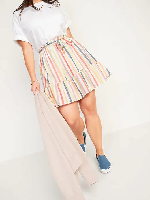 Model wears High-Waisted Tiered Striped Mini Swing Skirt in rainbow stripe. Image via Old Navy.