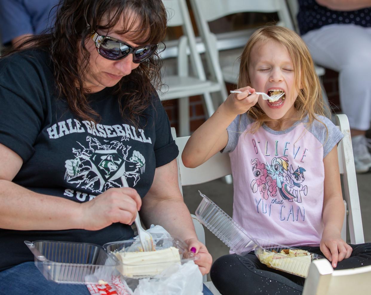 Stacy Ostoich of West Allis and her niece Madeline Wied, 5, of Waukesha enjoy strawberry cake during Cedarburg's 34th annual Strawberry Festival in 2019. This year's festival is June 25 and 26.