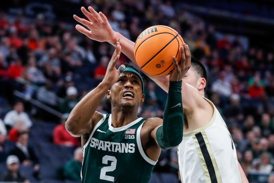 Michigan State guard Tyson Walker (2) makes a layup against Purdue center Zach Edey (15) during the first half of quarterfinal of Big Ten tournament at Target Center in Minneapolis, Minn. on Friday, March 15, 2024.