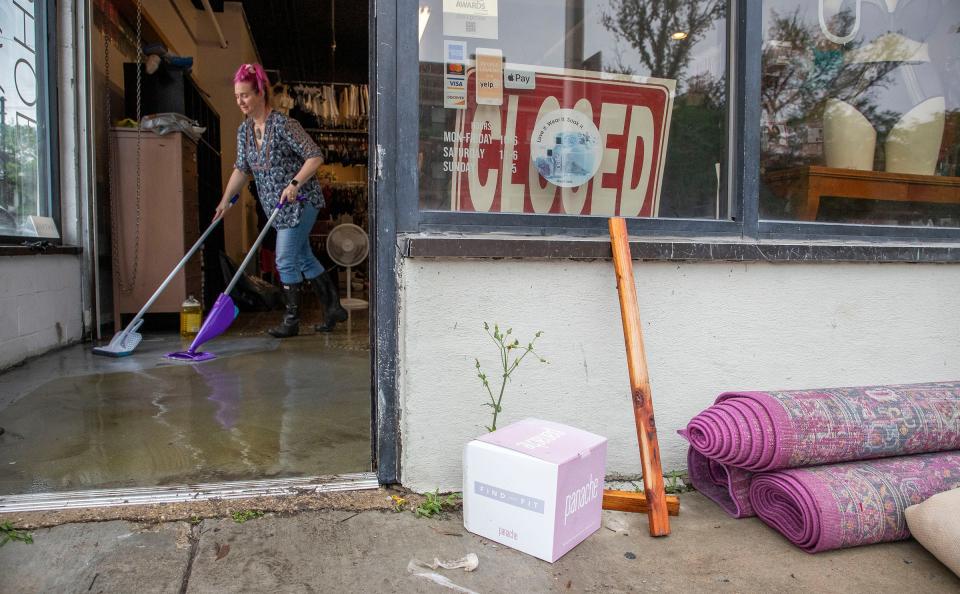 Lee Padgett, the owner of Busted Bra Shop at the corner of Jefferson and Chalmers, uses a mop to try and dry up the water that flooded her shop overnight on Saturday, June 26, 2021, in Detroit. Heavy rains in metro Detroit caused massive flooding in homes, streets, and freeways. This would have normally been their busiest day of the week.