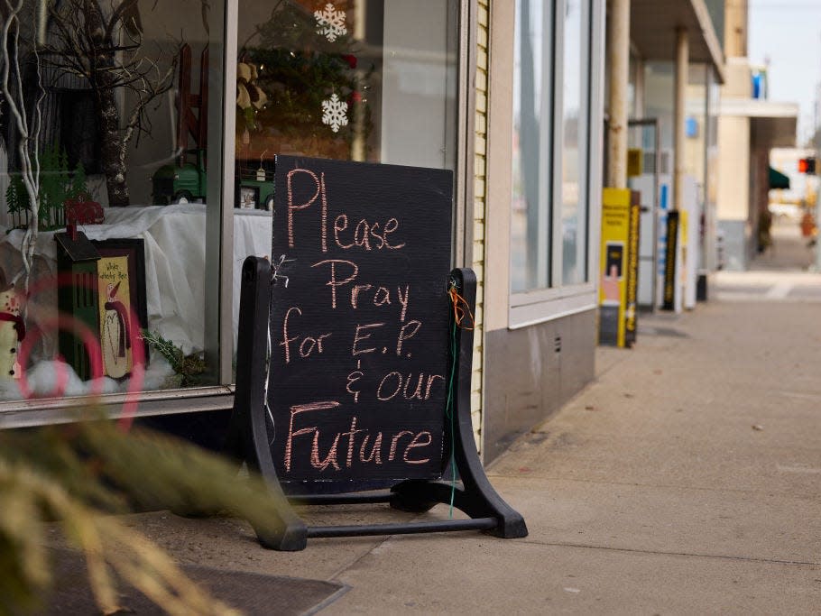 A sign reads “Please pray for E.P. and our future,” outside a shop in East Palestine.