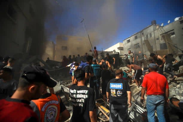 Civil defense teams and locals carry out search and rescue operations after an Israeli attack hits Shaqwra family apartment in Khan Yunis, Gaza on 06 November 2023 (Middle East Images/AFP via Getty)