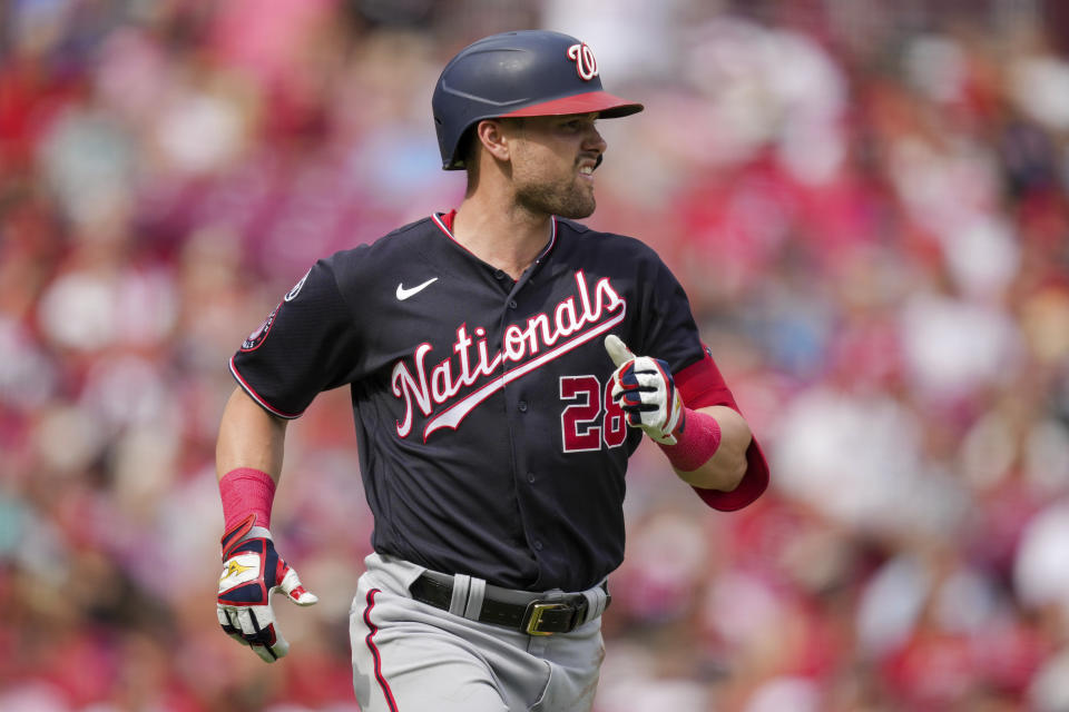 Washington Nationals' Lane Thomas watches his sacrifice fly during the second inning of a baseball game against the Cincinnati Reds in Cincinnati, Saturday, Aug. 5, 2022. (AP Photo/Aaron Doster)