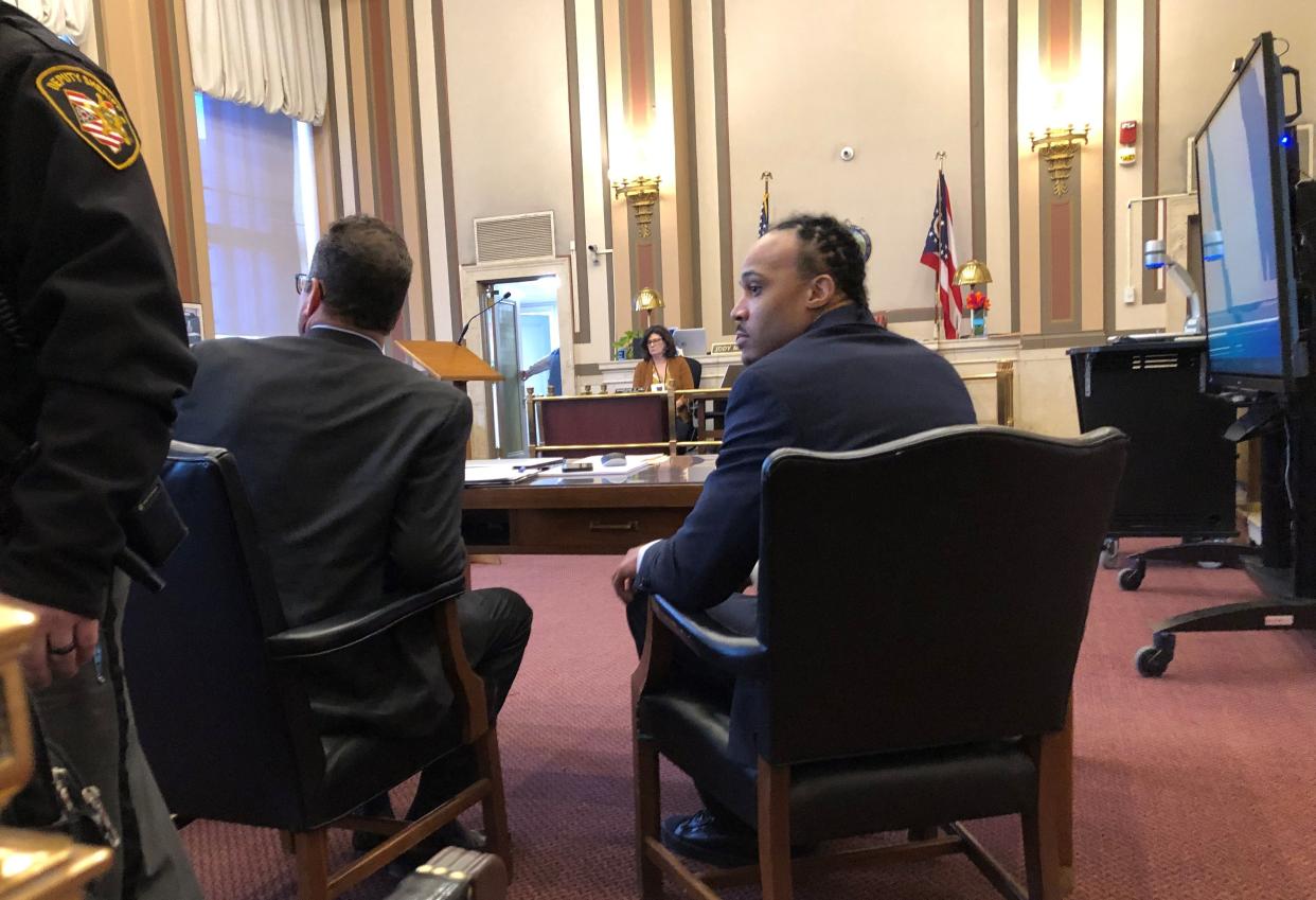 Jahmon Akins, at right, sits at the defense table next to his attorney, Paul Laufman, awaiting opening statements in his murder trial in Hamilton County Common Pleas Court in March.