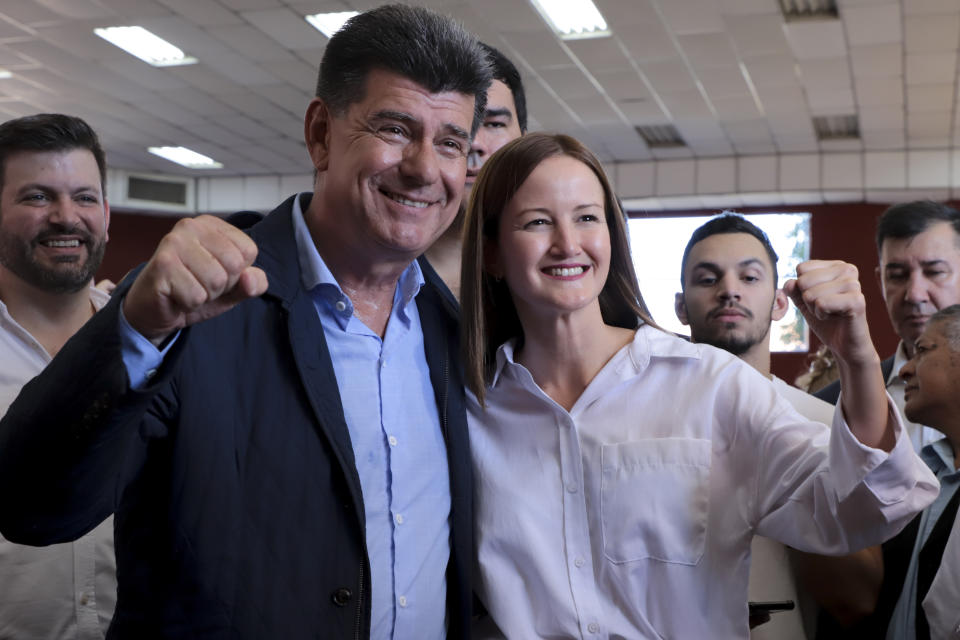 Efrain Alegre, presidential candidate for the Concertacion coalition, and running mate Soledad Nunez pose for a picture at a polling station during general elections in Lambare, outskirts Asuncion, Sunday, April 30, 2023. (AP Photo/Marta Escurra)