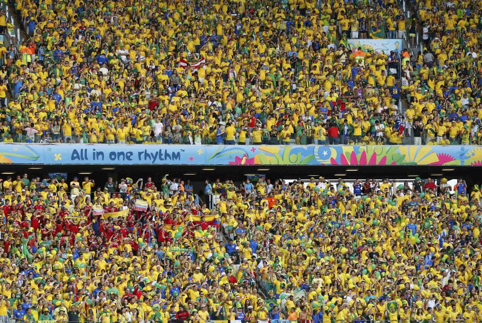 Fans wait for the start of the 2014 World Cup quarter-finals between Colombia and Brazil at the Castelao arena in Fortaleza July 4, 2014. REUTERS/Yves Herman