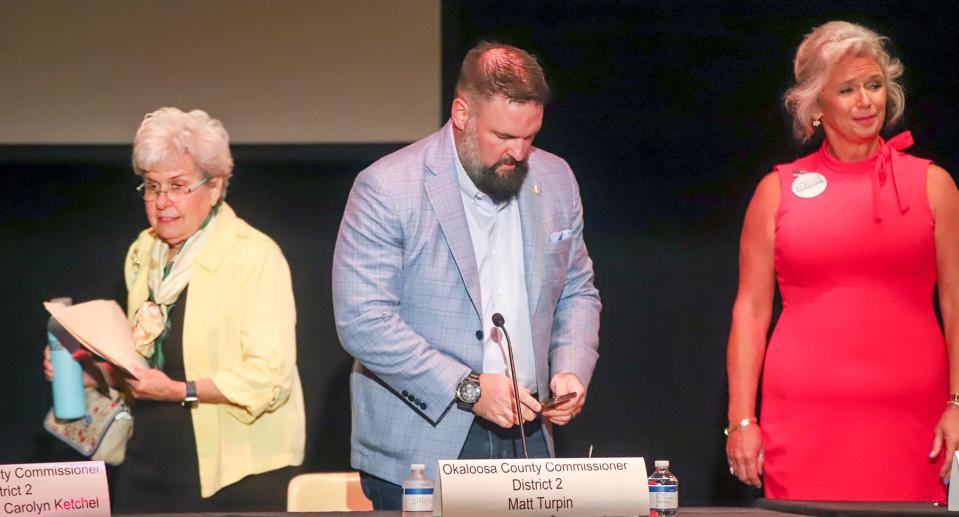 Carolyn Ketchel, Matt Turpin and CareySue Beasley (from left) take the stage during a forum for candidates running for the Okaloosa County Commission District 2 seat.