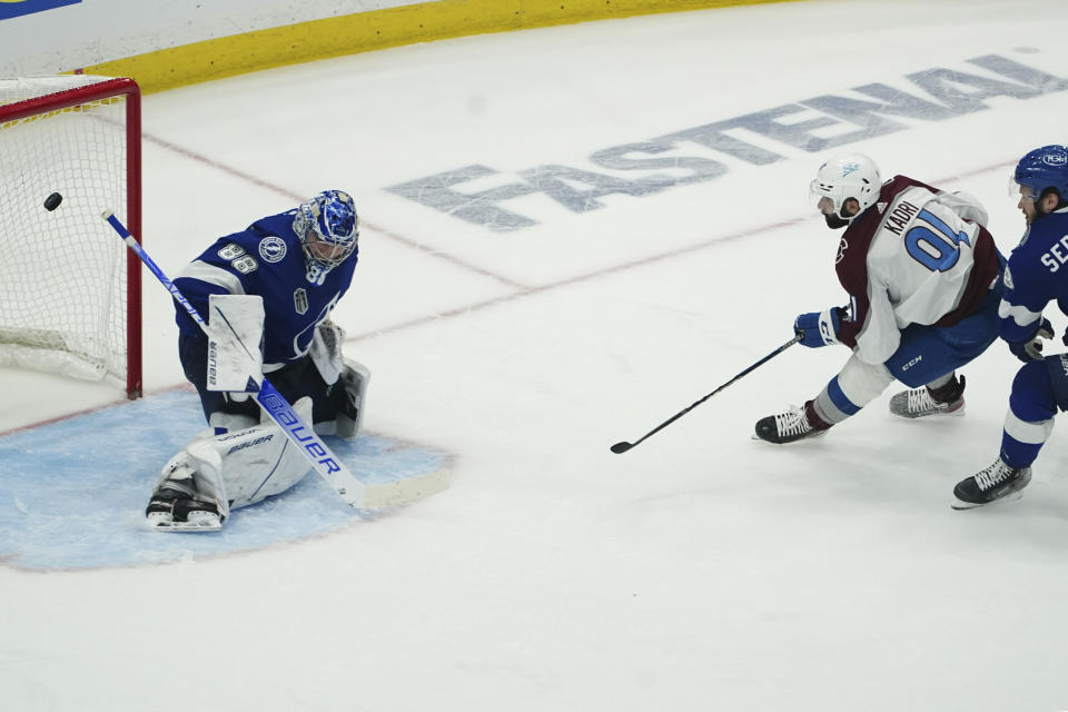 Colorado Avalanche center Nazem Kadri (91) shoots the puck past Tampa Bay Lightning goaltender Andrei Vasilevskiy (88) for a goal during overtime of Game 4 of the NHL hockey Stanley Cup Finals on Wednesday, June 22, 2022, in Tampa, Fla. (AP Photo/John Bazemore)