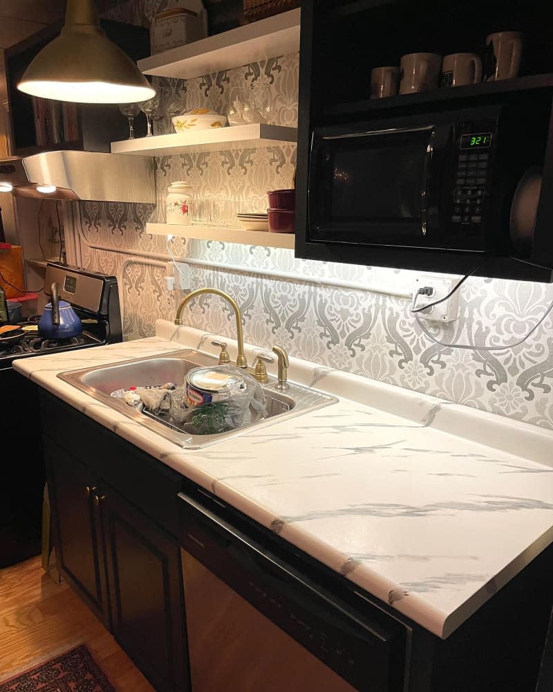 Silver and white wallpaper in kitchen.