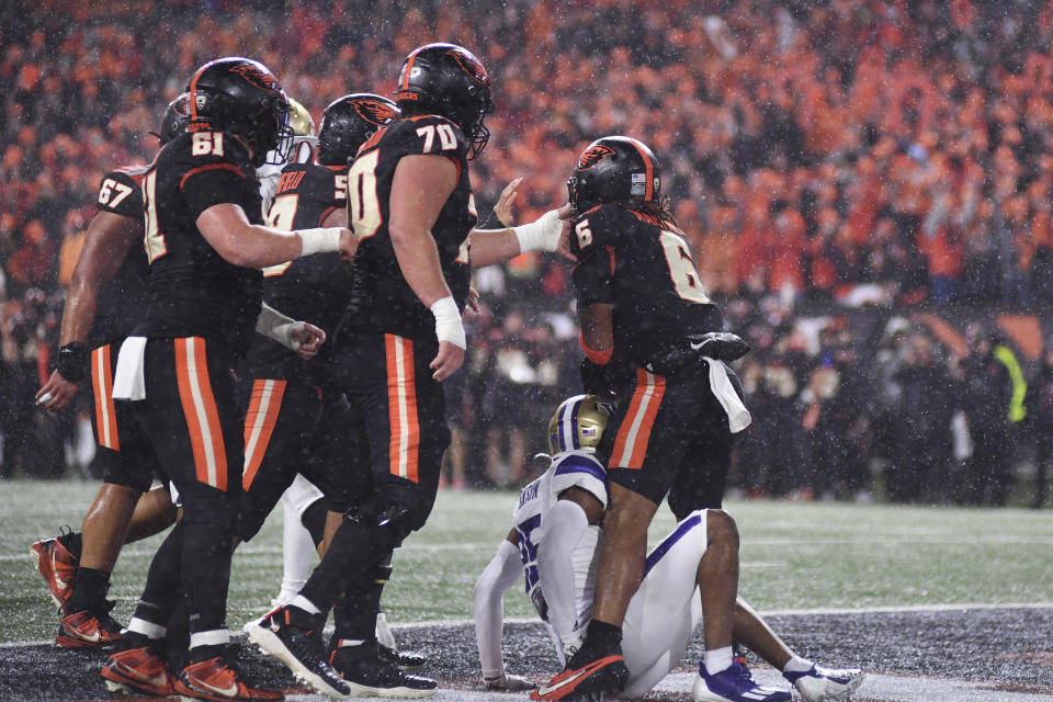 Oregon State running back Damien Martinez (6) celebrates his touchdown against Washington with teammates during the first half of an NCAA college football game Saturday, Nov. 18, 2023, in Corvallis, Ore. (AP Photo/Mark Ylen)