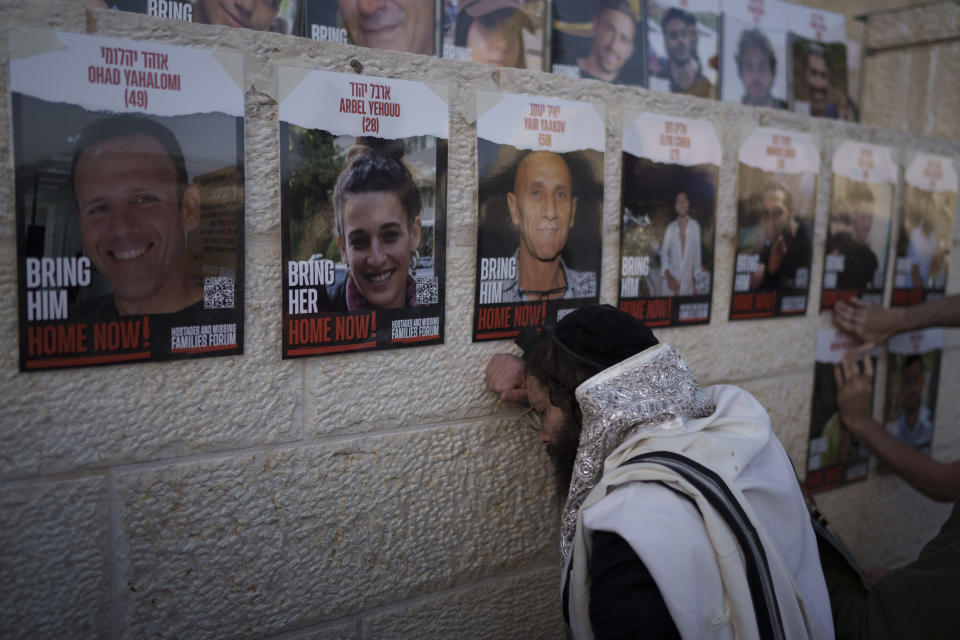 People attend a mass public prayer calling for the hostages held in the Gaza Strip to be released in front of the Western Wall, the holiest site where Jews can pray, in Jerusalem's Old City, Israel, Wednesday, Jan. 10, 2024. In its Oct. 7 attack, Hamas and other militants took captive roughly 250 people, including men, women, children and older people. Around 110 people have been released and some 110 remain, along with about 20 people who were killed while in captivity, Israeli authorities say. (AP Photo/Leo Correa)