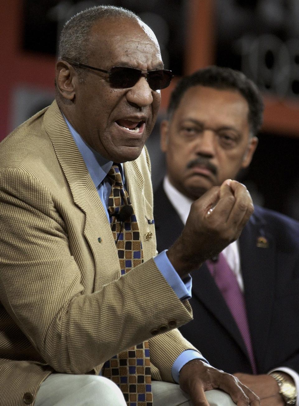 In this 2004 file photo, Bill Cosby and Jesse Jackson attend an annual conference for civil rights organization Rainbow Push Coalition.