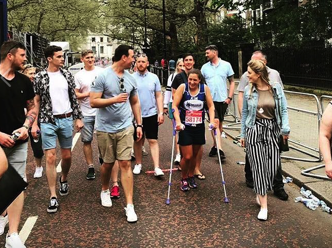 Kim was assisted over the finish line by her family and friends