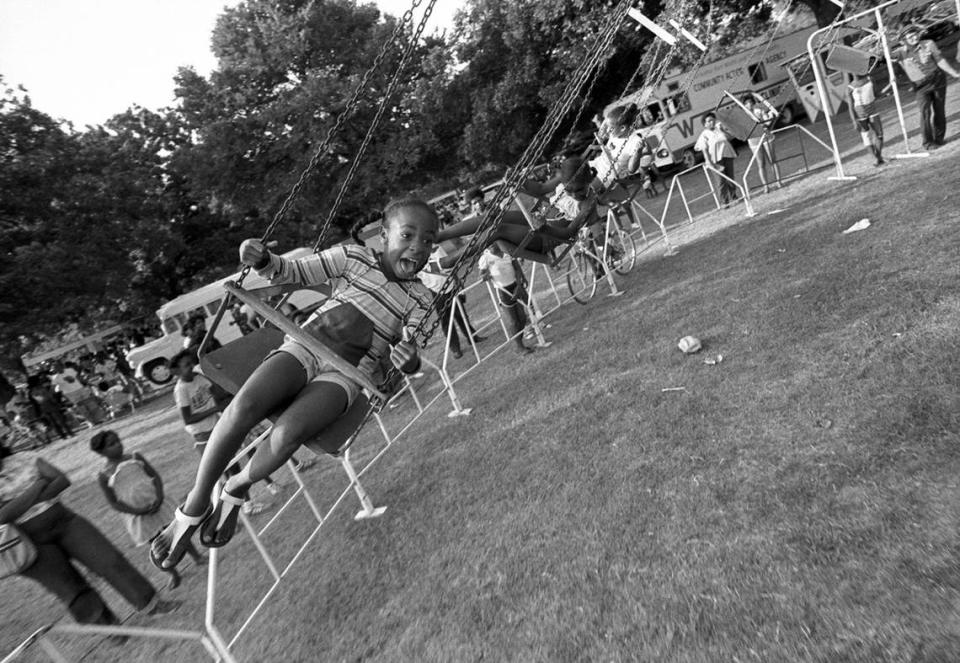 Lisa Jackson, 7, joins in the Juneteenth celebration at Sycamore Park in Fort Worth with a ride in a swing in 1977.