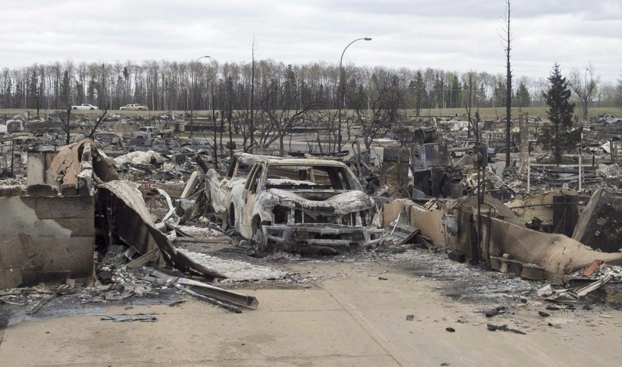 <span class="caption">As climate change brings longer and drier summers, Canadians will face greater risks of more serious wildfires, like those that tore through neighbourhoods in Fort McMurray, Alta., in May 2016.</span> <span class="attribution"><span class="source">THE CANADIAN PRESS/Ryan Remiorz</span></span>