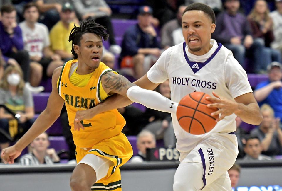 Holy Cross' Joe Octave, right, shown in a game last season, turned in his first career double-double Saturday night against Georgetown.