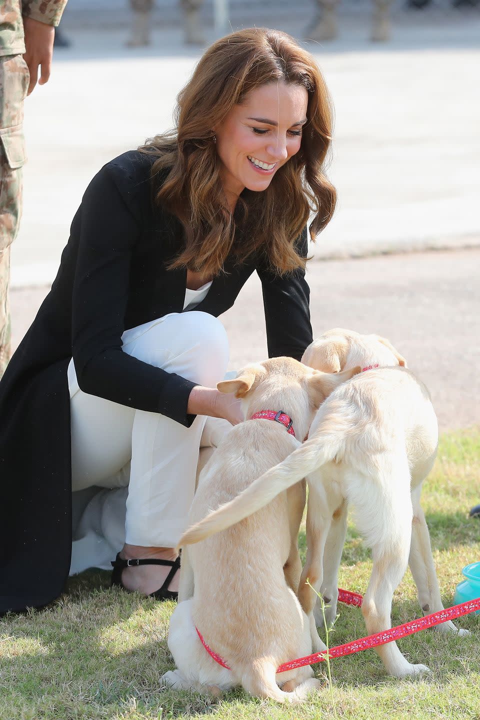 <p>The duchess stops to play with puppies at the Army Canine Centre in Islamabad, Pakistan.</p>