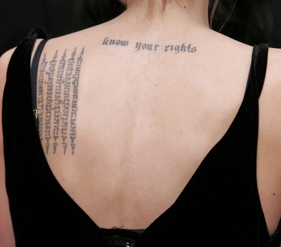 "Know your rights" on her back near the nape of her neck