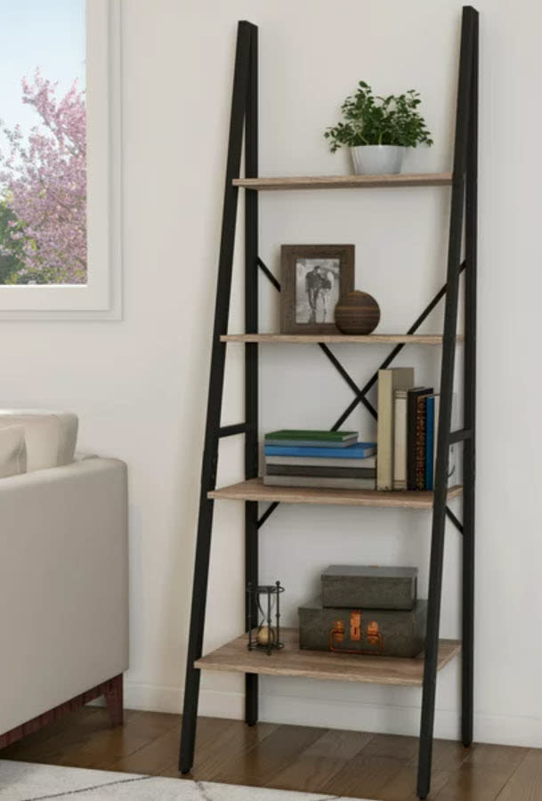 leaning bookcase with books displayed