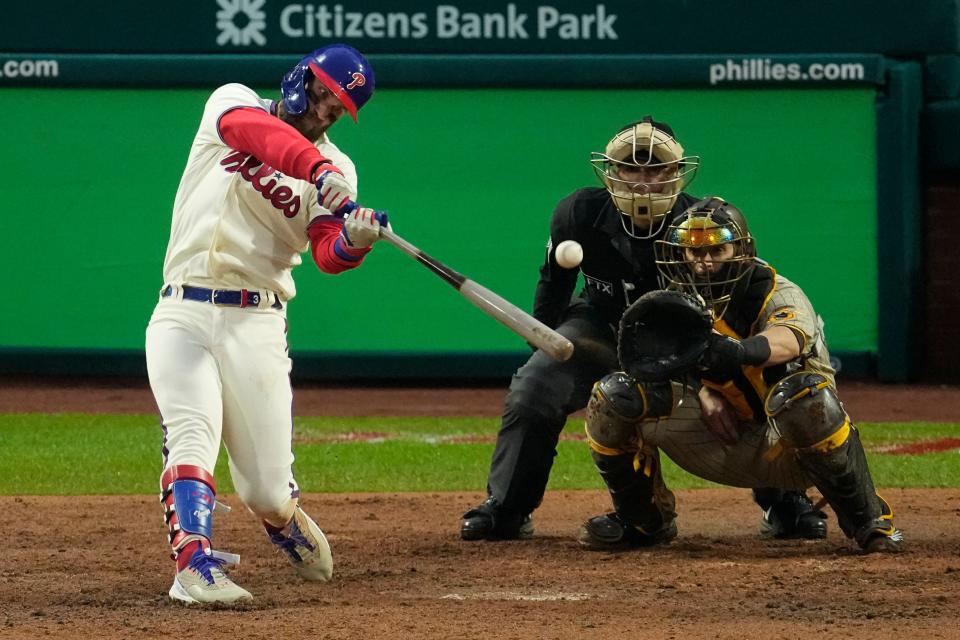 Philadelphia Phillies' Bryce Harper hits a two-run home run during the eighth inning in Game 5 of the baseball NL Championship Series between the San Diego Padres and the Philadelphia Phillies on Sunday, Oct. 23, 2022, in Philadelphia. (AP Photo/Matt Rourke)