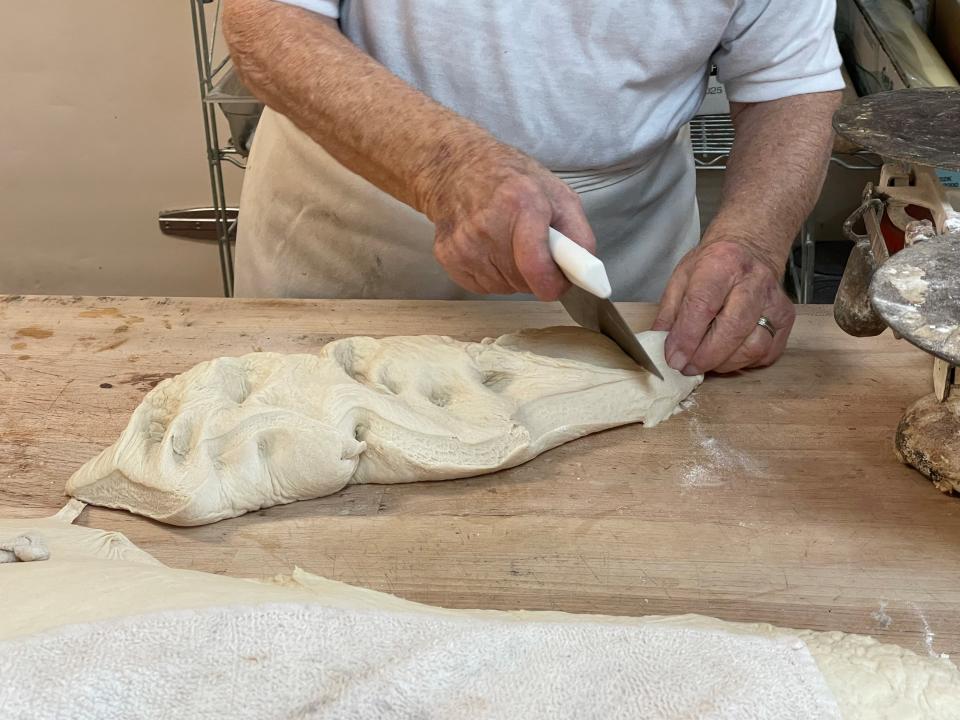 Tony Weible cuts the dough for Austria rolls, which are simple yeast rolls that, according one customer at Andrew's Pastries in Marion, are good as hamburger buns.