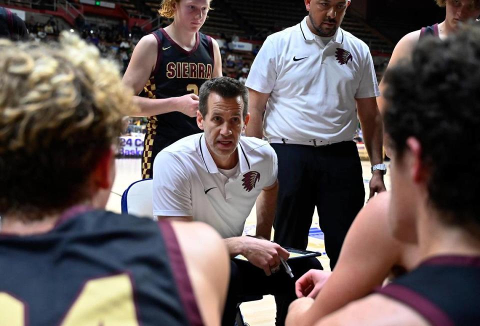 Sierra’s head coach Ryan Watt, center, talks to the team during a timeout against North in the Central Section Division III Boys basketball championship Saturday, Feb. 24, 2024 at Selland Arena in Fresno..