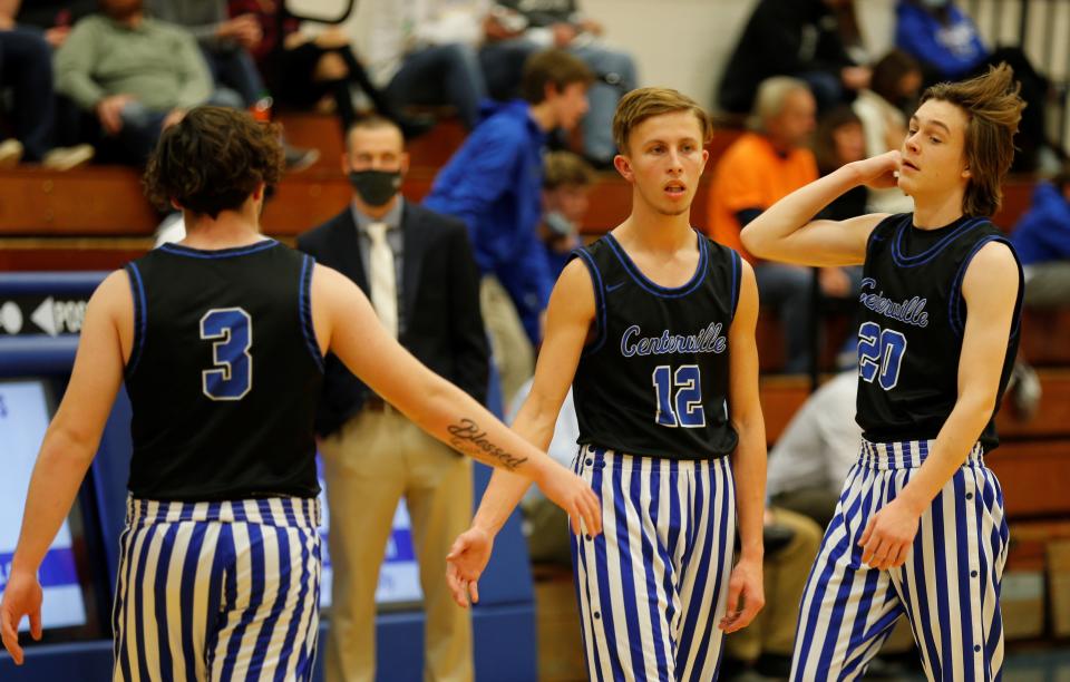 Centerville senior Jacob Fordonski (12) and sophomore Gavin Robinson (3) slap hands while freshman Grady Blake (20) flips his hair  during warmups before a game against Randolph Southern Jan. 15, 2022.