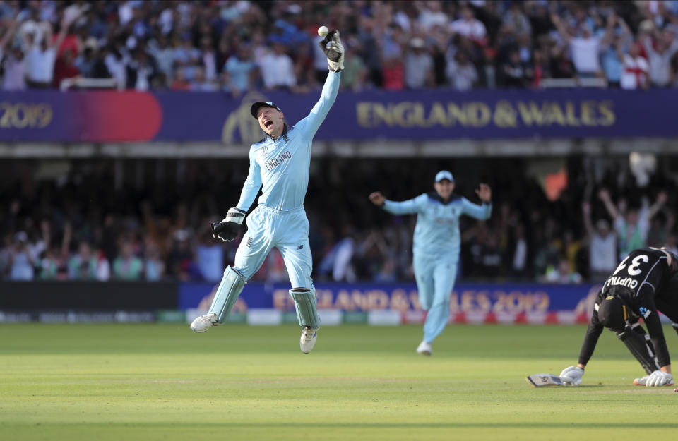 England's Jos Buttler celebrates after running out New Zealand's Martin Guptill, right, during the Super Over in the Cricket World Cup final match between England and New Zealand at Lord's cricket ground in London, England, Sunday, July 14, 2019. (AP Photo/Aijaz Rahi)