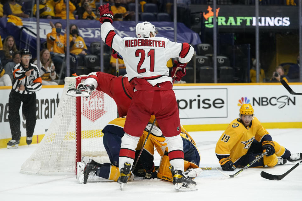 Carolina Hurricanes right wing Nino Niederreiter (21) celebrates after teammate Vincent Trocheck scored against the Nashville Predators during the first period in Game 4 of an NHL hockey Stanley Cup first-round playoff series Sunday, May 23, 2021, in Nashville, Tenn. (AP Photo/Mark Humphrey)