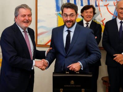 Spain's Culture Minister Maxim Huerta receives the ministerial briefcase from outgoing minister Inigo Mendez de Vigo at the Culture Ministry in Madrid, Spain June 7, 2018.  REUTERS/Paul Hanna