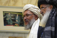 Abdul Salam Hanafi, a deputy prime minister in the Taliban's interim government, left, walks during talks involving Afghan representatives in Moscow, Russia, Wednesday, Oct. 20, 2021. Russia hosted talks on Afghanistan on Wednesday involving senior representatives of the Taliban and neighboring nations, a round of diplomacy that underlines Moscow's clout. Russian Foreign Minister Sergey Lavrov opened the talks and emphasized that "forming a really inclusive government fully reflecting the interests of not only all ethnic groups but all political forces of the country" is necessary to achieve a stable peace in Afghanistan. (AP Photo/Alexander Zemlianichenko, Pool)