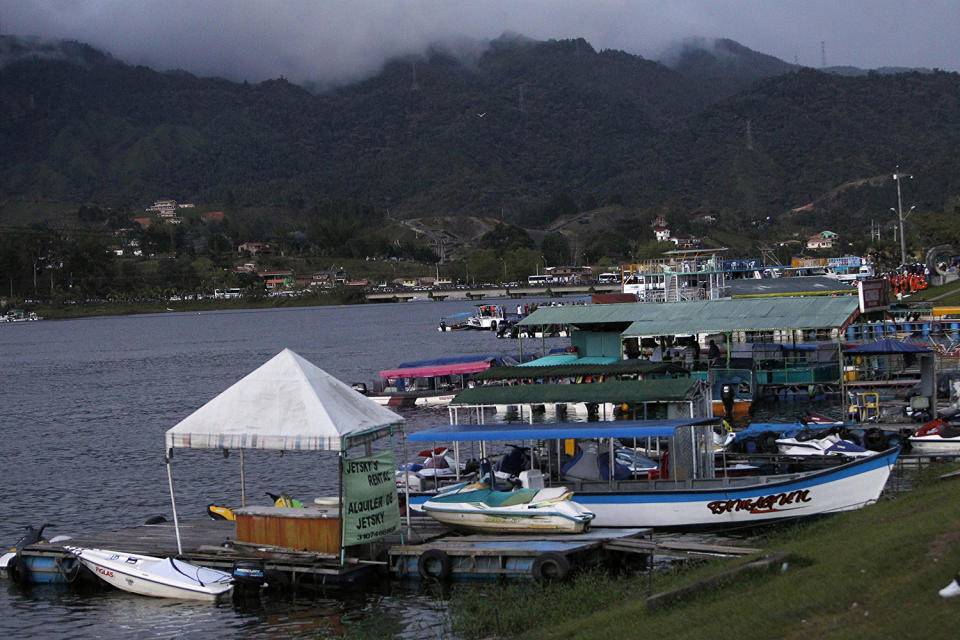 <p>Boats are docked at the reservoir where a ferry sank in Guatape, Colombia, June 25, 2017. (Luis Benavides/AP) </p>