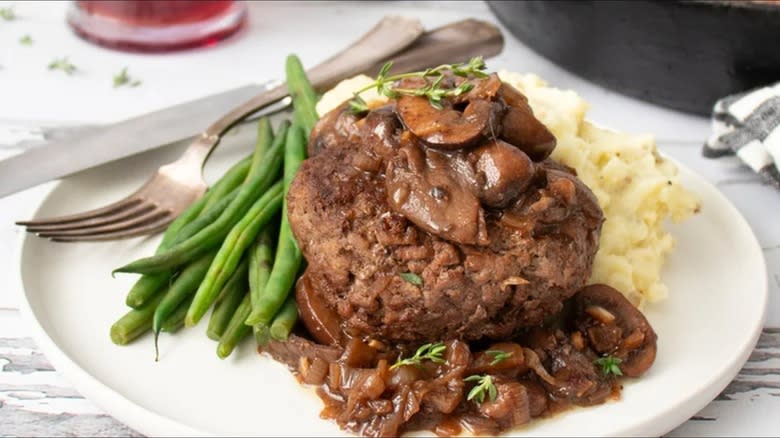 red wine and truffle chopped steak over mashed potatoes with green beans