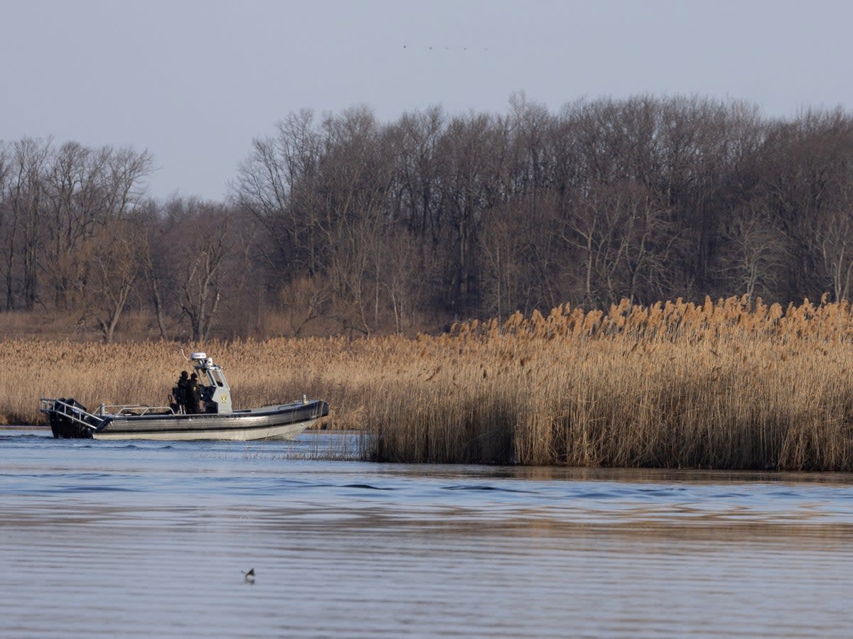 Police search the marshland where bodies were found in Akwesasne, Quebec, Canada March 31, 2023.  REUTERS/Christinne Muschi (REUTERS)