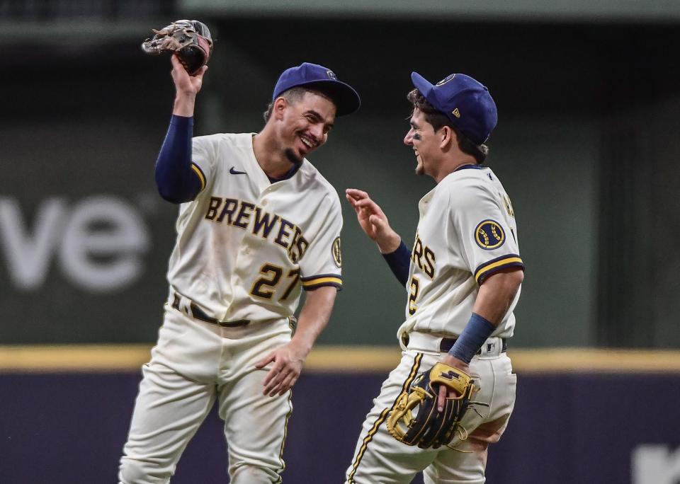 Sep 8, 2022; Milwaukee, Wisconsin, USA; Milwaukee Brewers shortstop Willy Adames (27) and second baseman Luis Urias (2) laugh during the sixth inning against the San Francisco Giants at American Family Field. Mandatory Credit: Benny Sieu-USA TODAY Sports