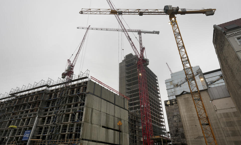 FILE - Cranes are pictured at a construction site at the famous shopping road 'Kurfuerstendamm' in Berlin, Germany, Monday, Dec. 5, 2022. The German government said Europe's largest economy was in “troubled waters” and slashed its growth forecast for this year as it struggles with a lack of skilled labor, excessive bureaucracy, high interest rates and lagging investment in new projects — while a relatively modest set of tax breaks for business remains blocked in the legislature. (AP Photo/Michael Sohn, File)