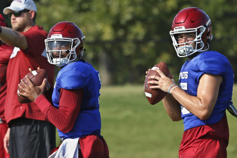 FILE - In this Monday, Aug. 5, 2019, file photo, Oklahoma quarterbacks Jalen Hurts, left, and Tanner Mordecai, right, throw during NCAA college football practice in Norman, Okla. Hurts is competing with Mordecai, a redshirt freshman, and Spencer Rattler, a true freshman, to become starting quarterback. (AP Photo/Sue Ogrocki, File)
