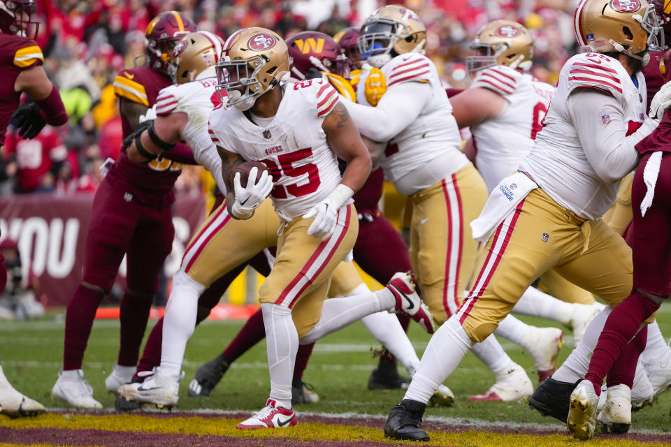 San Francisco 49ers running back Elijah Mitchell (25) runs in to score a touchdown against the Washington Commanders during the second half of an NFL football game, Sunday, Dec. 31, 2023, in Landover, Md. (AP Photo/Mark Schiefelbein)