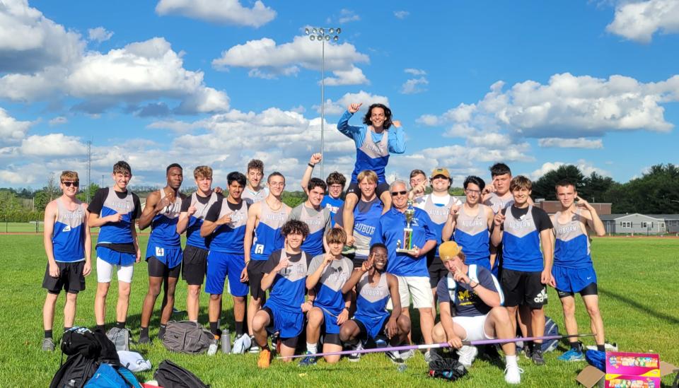 The Auburn High boys' track team celebrates its victory Tuesday at the SWCL Championships in Oxford.