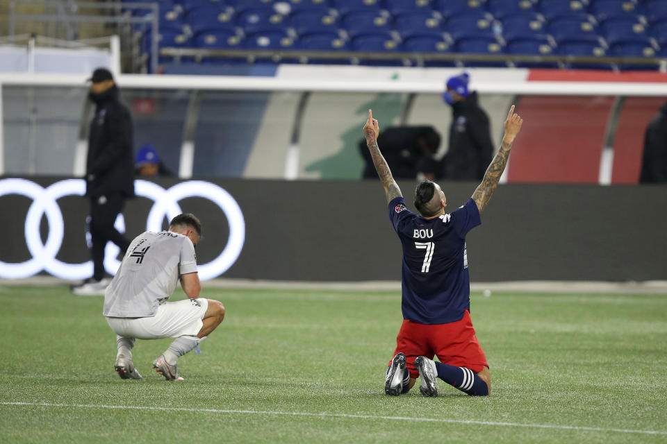 New England Revolution forward Gustavo Bou (7) celebrates as the final whistle blows, next to Montreal Impact defender Rudy Camacho in an MLS soccer match, Friday, Nov. 20, 2020, in Foxborough, Mass. The Revolution won 2-1. (AP Photo/Stew Milne)