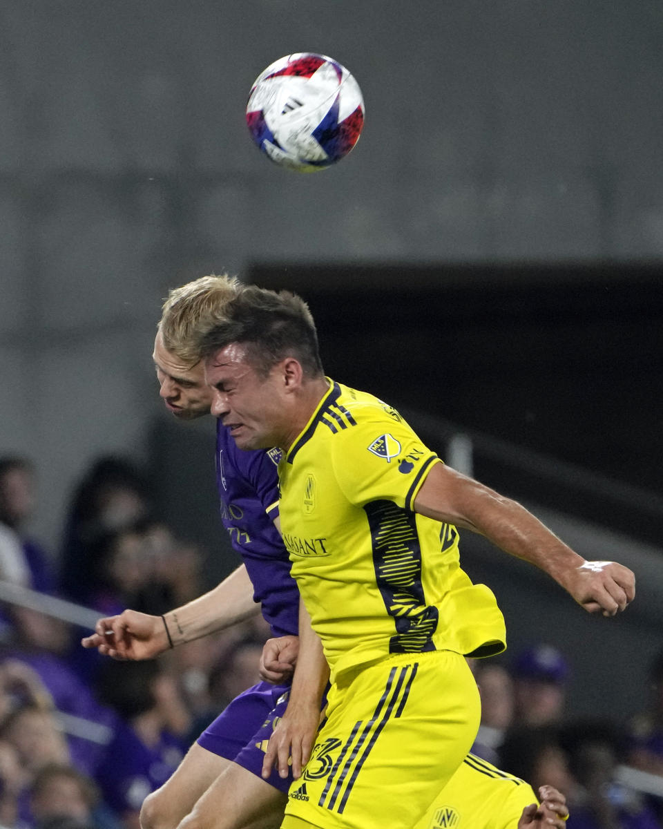 Orlando City's Dagur Thorhallsson, left, and Nashville SC's Taylor Washington go up to get position on a head ball during the second half of an MLS soccer match, Saturday, April 1, 2023, in Orlando, Fla. (AP Photo/John Raoux)