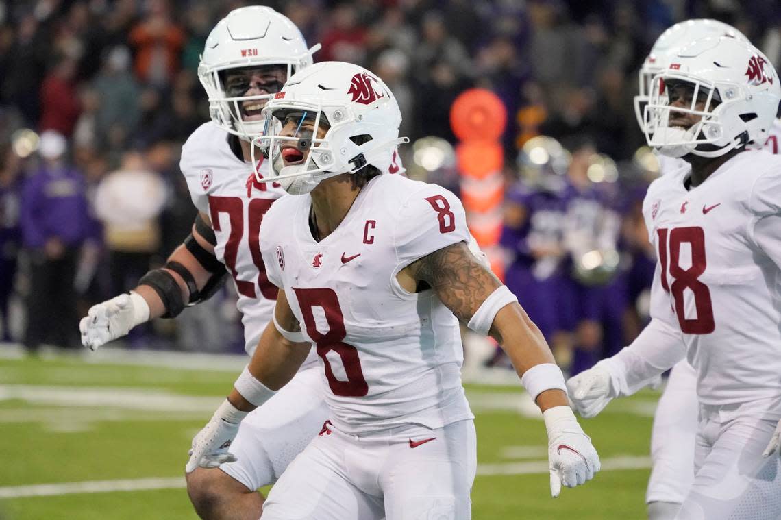 Washington State defensive back Armani Marsh (8) celebrates after intercepting a pass for a touchdown against Washington during the second half of an NCAA college football game Friday, Nov. 26, 2021, in Seattle. Washington State won 40-13. (AP Photo/Ted S. Warren)